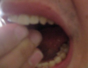 Three fingers in mouth